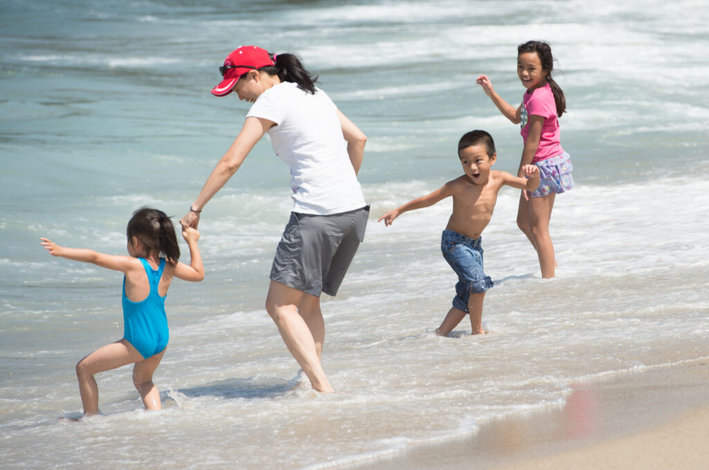 Family playing at the tideline at Redondo Beach
