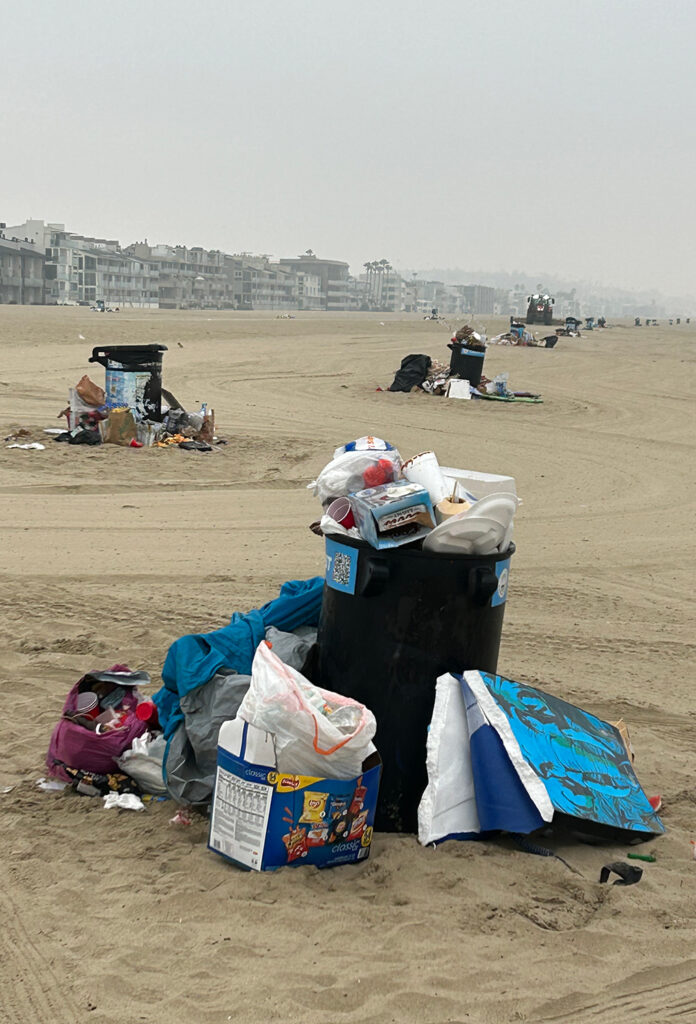 Overflowing trash barrels at Venice Beach the morning after July 4, 2025.